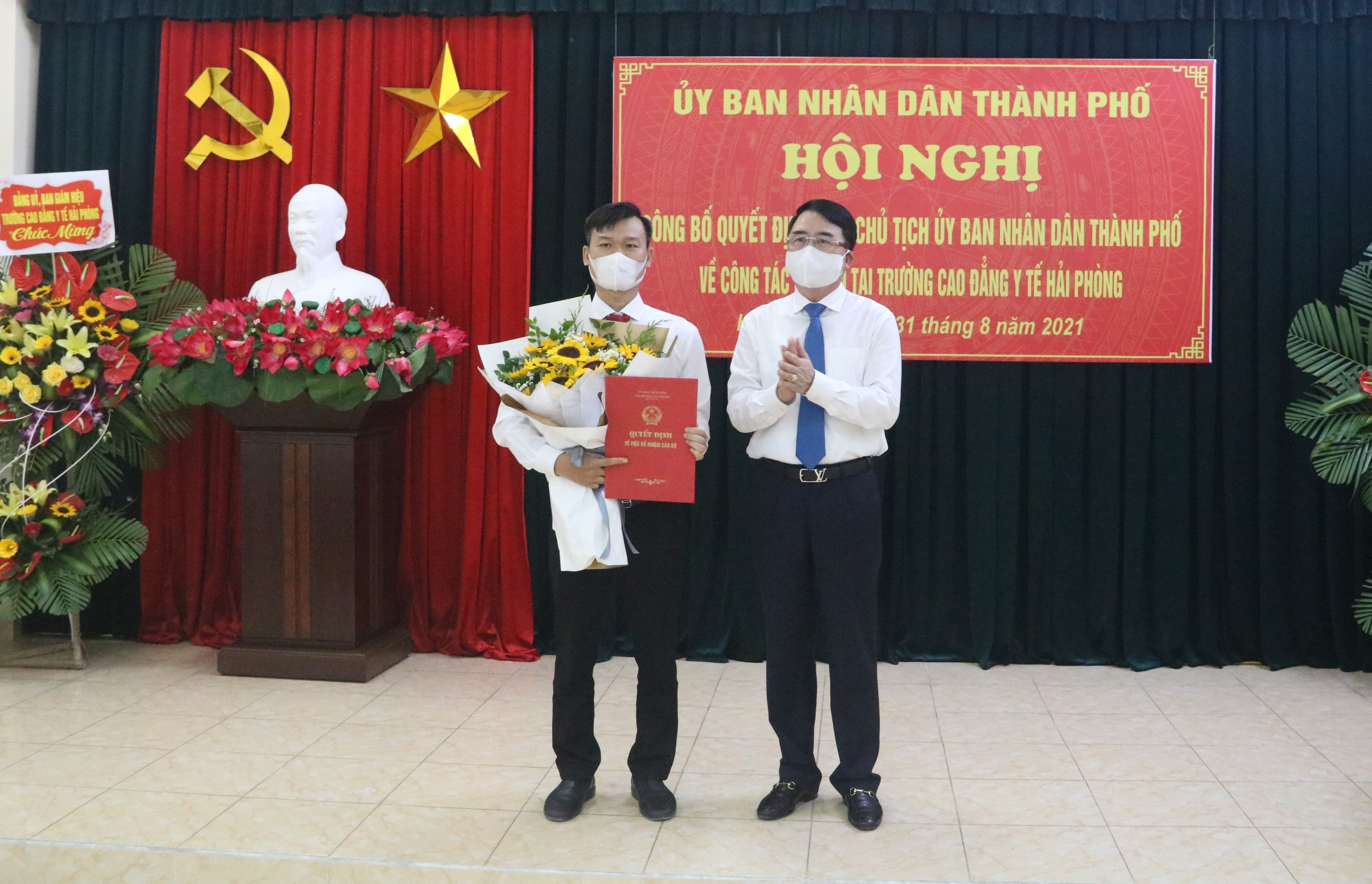 Đồng chí Lê Khắc Nam- Phó Chủ tịch UBND TP trao quyết định, tặng hoa chúc mừng tân Hiệu trưởng Trường Cao đẳng Y tế Hải Phòng. 